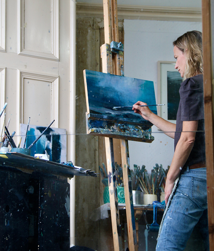 artist helen glassford painting in her studio