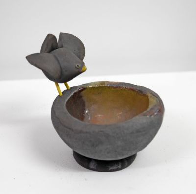 raku bird's nest, with black bird by Chris Barnes