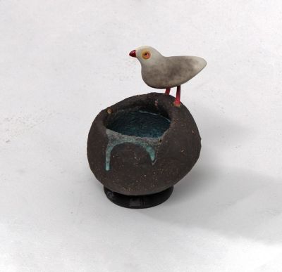 grey bird on black nest by Chris Barnes